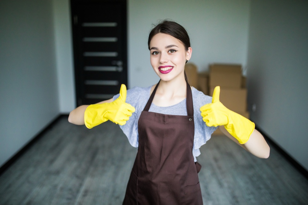 Smiling worker giving two thumbs up on the job